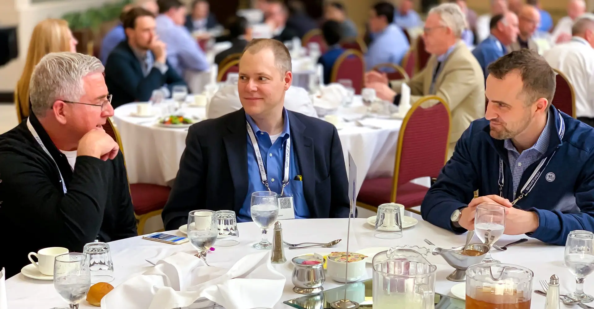 Hands-on dialogue between senior leaders at table discussions